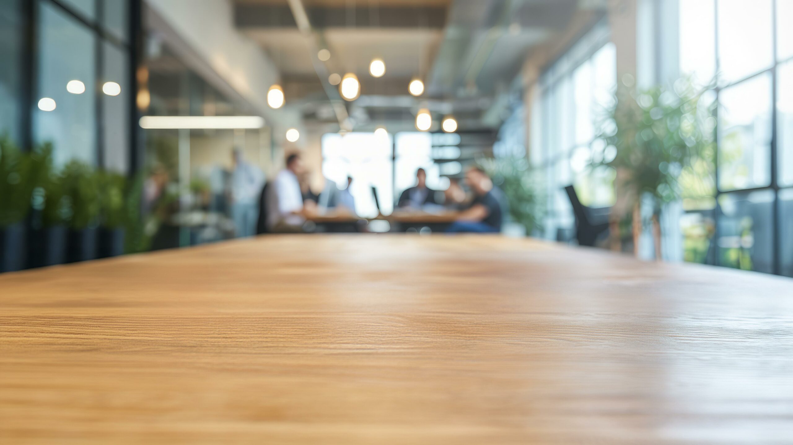 Empty desk in modern office. Wooden desk for your product in bright modern coworking space, blurred background